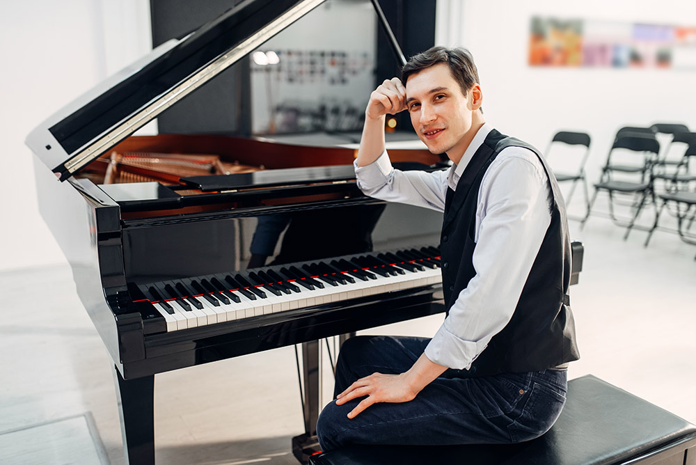 Professional pianist at the black grand piano